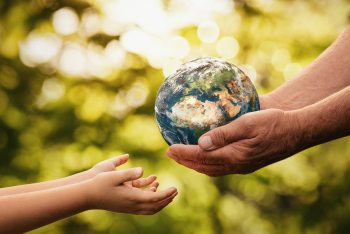Person handing earth to a child